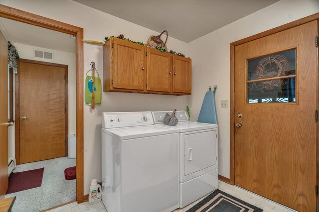 102 Robinson Dr, Morris, IL 60450 - clothes washing area with washer and dryer, cabinet space, baseboards, baseboard heating, and light floors