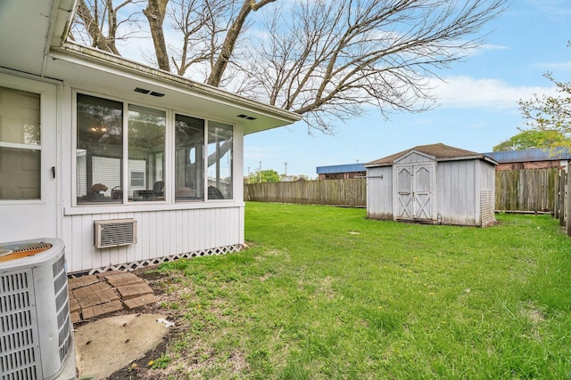 102 Robinson Dr, Morris, IL 60450 - view of yard featuring central air condition unit, a shed, a sunroom, and an outdoor structure