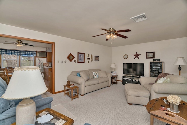 102 Robinson Dr, Morris, IL 60450 - living area featuring ceiling fan, carpet floors, and baseboards