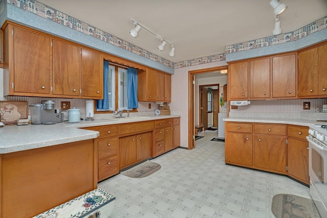 102 Robinson Dr, Morris, IL 60450 - kitchen featuring rail lighting, white stove, brown cabinetry, light floors, and light countertops