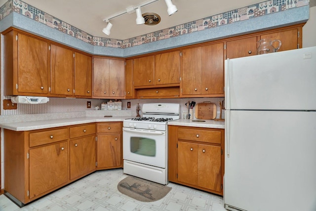 102 Robinson Dr, Morris, IL 60450 - kitchen with white appliances, rail lighting, and brown cabinetry