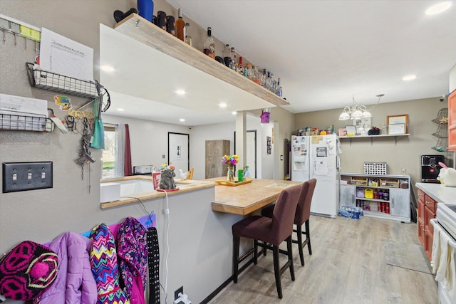 313 W S St, Pearl City, IL 61062 - kitchen featuring light wood-type flooring, white fridge with ice dispenser, recessed lighting, light countertops, and stove