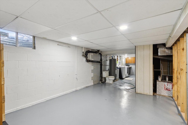 313 W S St, Pearl City, IL 61062 - below grade area featuring a paneled ceiling, separate washer and dryer, water heater, and concrete block wall