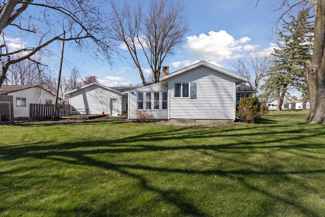 313 W S St, Pearl City, IL 61062 - back of property with a lawn and a chimney