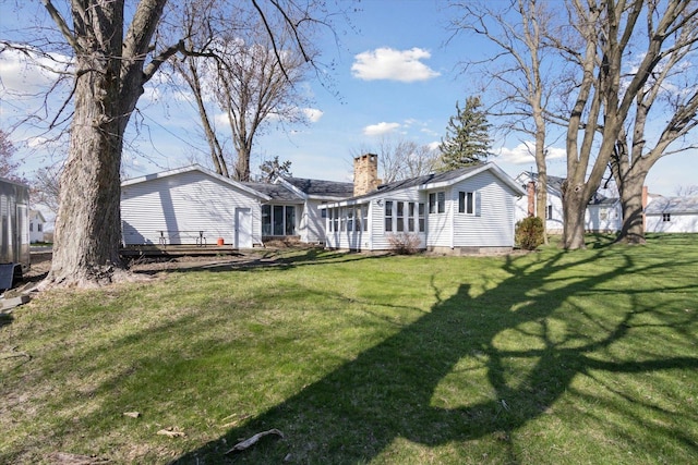 313 W S St, Pearl City, IL 61062 - rear view of property with a yard and a chimney