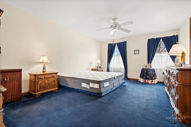 carpeted bedroom featuring ceiling fan and baseboards