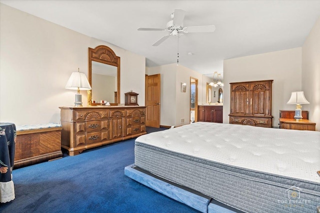 bedroom featuring dark colored carpet, a ceiling fan, and ensuite bathroom