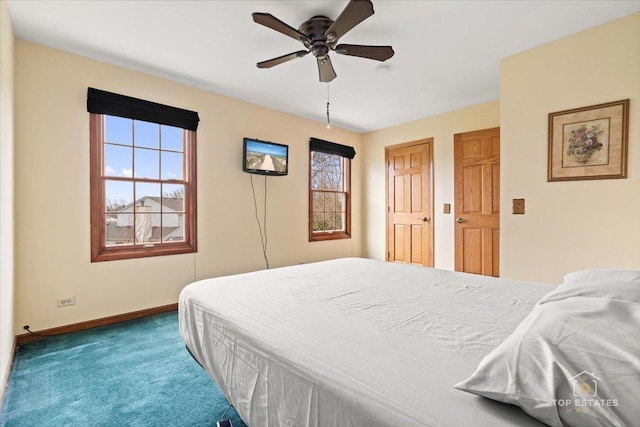 carpeted bedroom with ceiling fan and baseboards