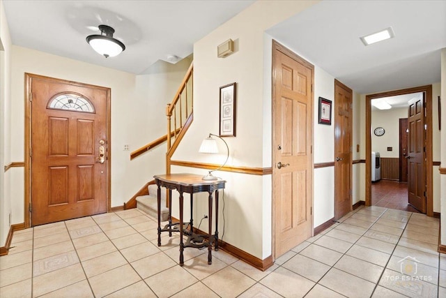 foyer with baseboards and light tile patterned floors