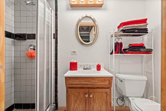 full bathroom with vanity, toilet, and a stall shower