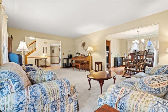 carpeted living room with a chandelier and stairs