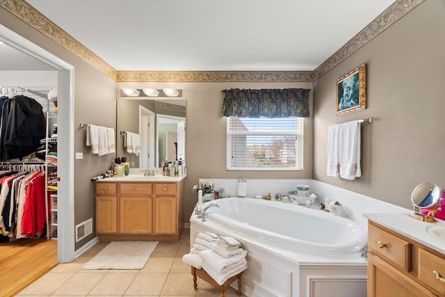 24117 Nottingham Ave, Plainfield, IL 60585 - full bathroom with vanity, a spacious closet, tile patterned floors, visible vents, and a bath