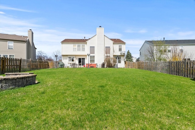 24117 Nottingham Ave, Plainfield, IL 60585 - rear view of house with a yard, a fenced backyard, and a chimney