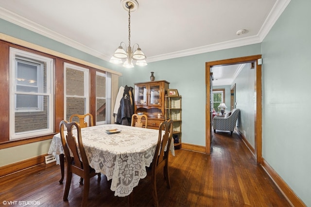 dining space featuring baseboards, an inviting chandelier, ornamental molding, and dark wood finished floors