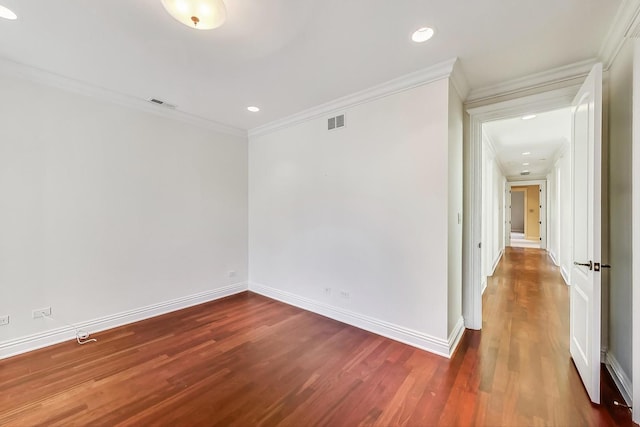 spare room with ornamental molding, wood finished floors, baseboards, and recessed lighting