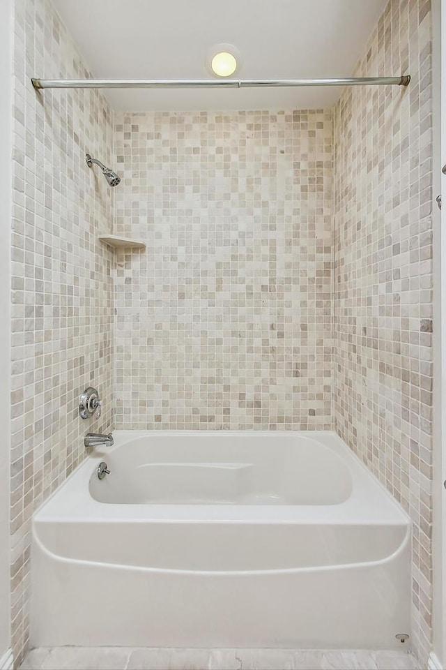 bathroom featuring tile walls, bathtub / shower combination, and tile patterned floors