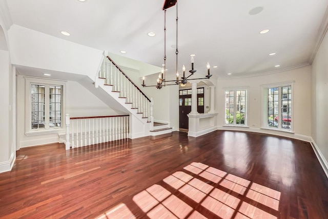 unfurnished dining area with wood finished floors, a chandelier, recessed lighting, ornamental molding, and baseboards