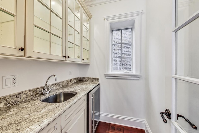 indoor wet bar with baseboards and wine cooler