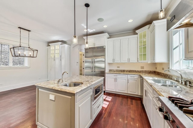 kitchen featuring a sink, built in appliances, dark wood-type flooring, white cabinetry, and recessed lighting