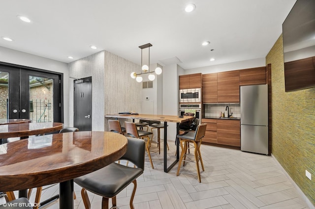 dining room with recessed lighting, french doors, wallpapered walls, and visible vents