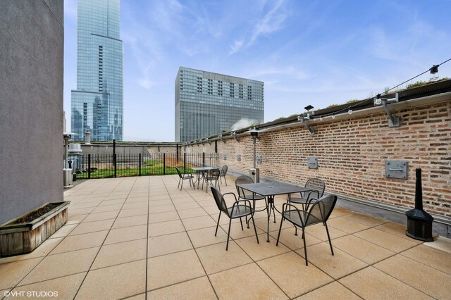 view of patio with outdoor dining space and fence