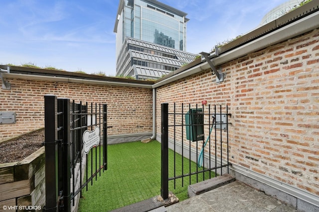 view of exterior entry featuring brick siding