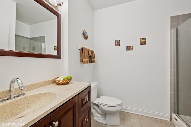 full bath with a tile shower, tile patterned flooring, toilet, and vanity