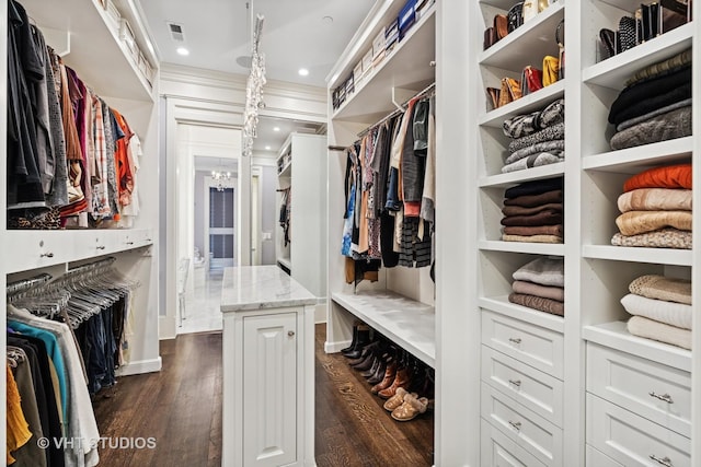2140 N Seminary Ave, Chicago, IL 60614 - walk in closet with dark wood-type flooring, visible vents, and an inviting chandelier