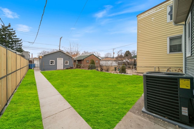 4616 N Kostner Ave, Chicago, IL 60630 - view of yard featuring central AC, a fenced backyard, and an outdoor structure