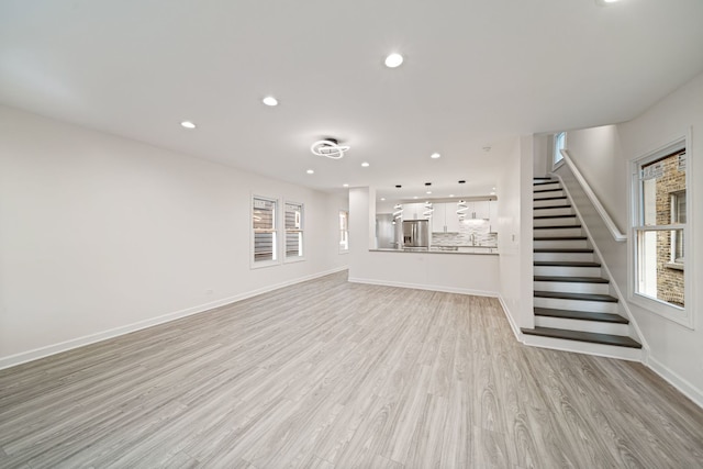 4616 N Kostner Ave, Chicago, IL 60630 - unfurnished living room with baseboards, light wood finished floors, recessed lighting, and stairs