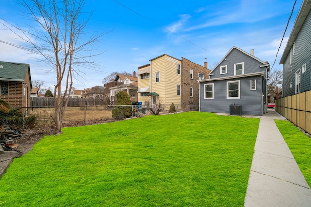 4616 N Kostner Ave, Chicago, IL 60630 - back of house featuring central AC, a fenced backyard, and a lawn