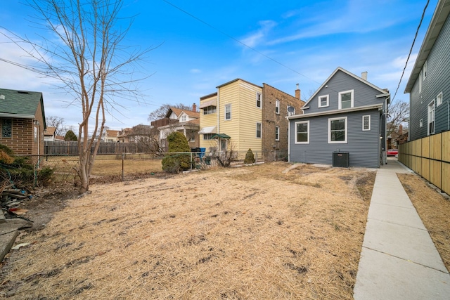 4616 N Kostner Ave, Chicago, IL 60630 - back of house with a residential view, central AC unit, and fence