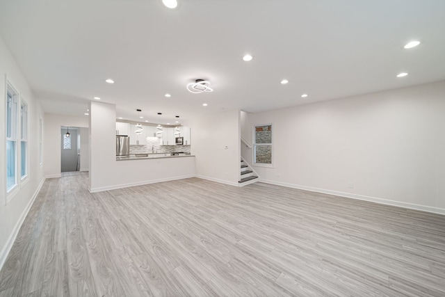 4616 N Kostner Ave, Chicago, IL 60630 - unfurnished living room featuring recessed lighting, stairway, light wood-style floors, and baseboards