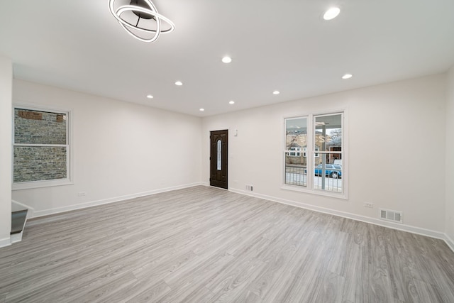 4616 N Kostner Ave, Chicago, IL 60630 - unfurnished living room with light wood-style floors, recessed lighting, visible vents, and baseboards