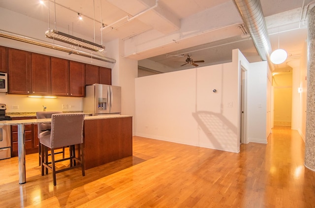 565 W Quincy St Unit 510, Chicago, IL 60661 - kitchen featuring stainless steel appliances, light wood-style flooring, ceiling fan, light countertops, and rail lighting