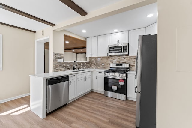 7730 Virginia Ct, Willowbrook, IL 60527 - kitchen featuring tasteful backsplash, a sink, white cabinetry, stainless steel appliances, and light wood-style flooring