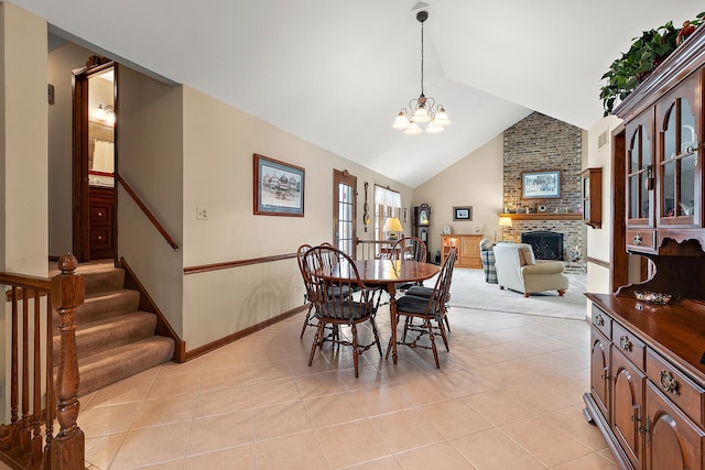 dining room with light tile patterned flooring, baseboards, a notable chandelier, stairway, and a fireplace