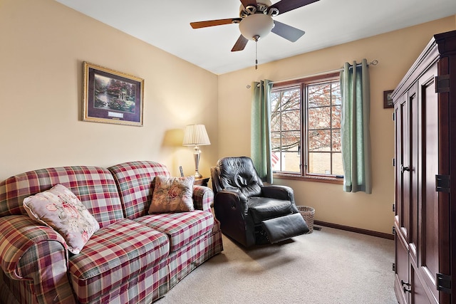 living area featuring light carpet, a ceiling fan, and baseboards
