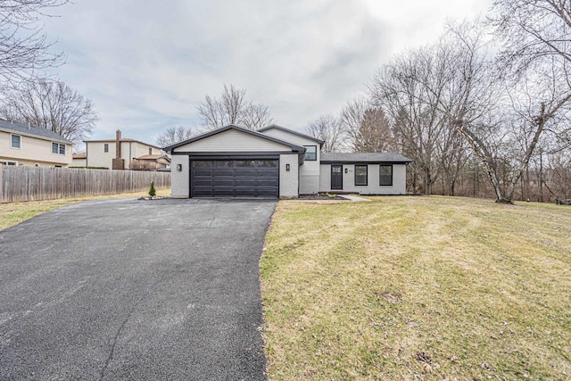 ranch-style home with an attached garage, aphalt driveway, brick siding, a front yard, and fence