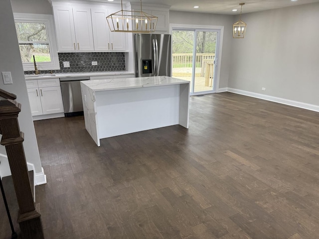 kitchen with a sink, a chandelier, stainless steel appliances, dark wood-style flooring, and recessed lighting