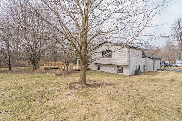 view of yard featuring cooling unit and a deck
