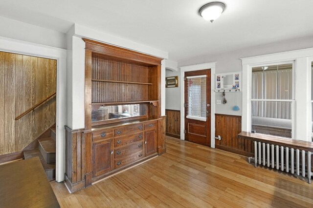 1856 Bernice Rd, South Holland, IL 60473 - interior space featuring radiator heating unit, stairs, light wood-type flooring, a wainscoted wall, and wood walls