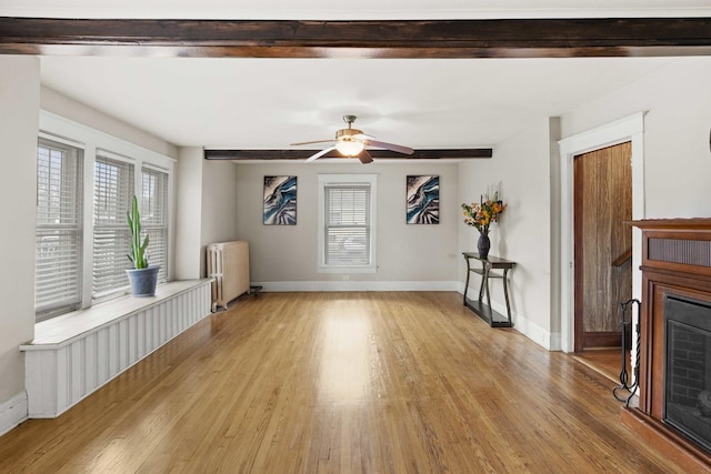 1856 Bernice Rd, South Holland, IL 60473 - unfurnished living room featuring radiator, light wood-style flooring, baseboards, and ceiling fan