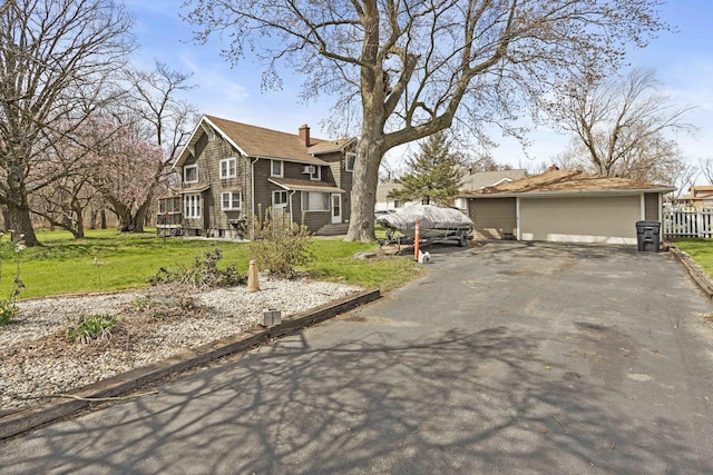 1856 Bernice Rd, South Holland, IL 60473 - view of front of house with fence, a chimney, a front yard, and a detached garage