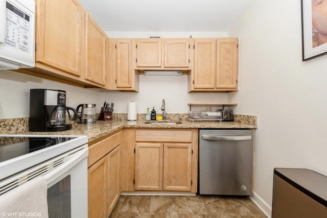 kitchen featuring baseboards, white appliances, light stone countertops, a sink, and light brown cabinetry