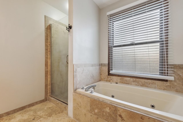 full bath with a stall shower and a whirlpool tub