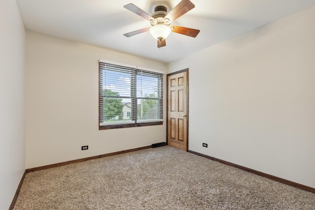 empty room with light carpet, a ceiling fan, and baseboards