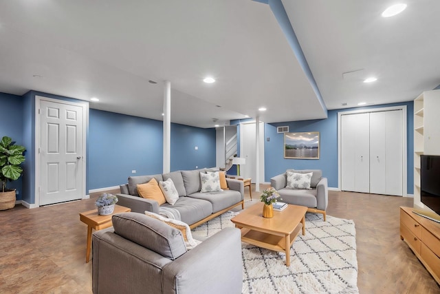 living room with baseboards and recessed lighting