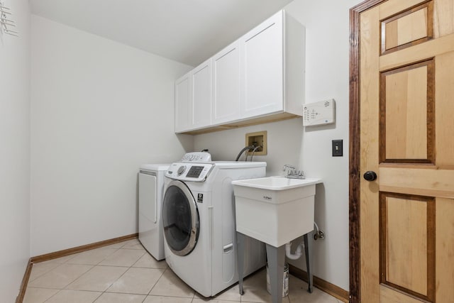 laundry room featuring cabinet space, washer and dryer, and baseboards