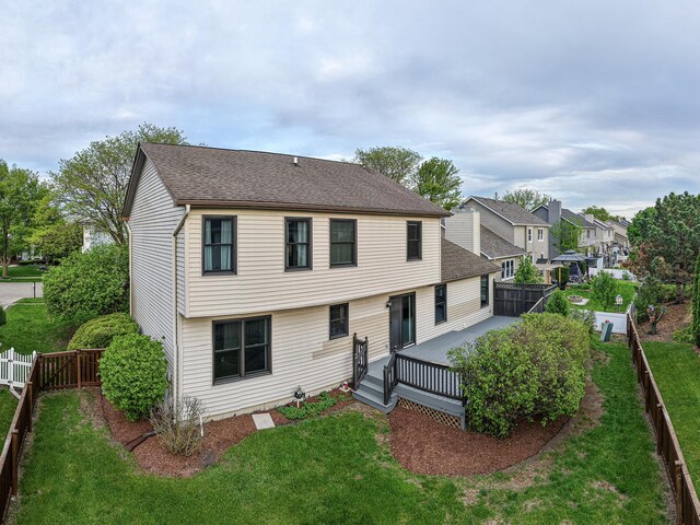 view of front of property featuring a deck, roof with shingles, and a residential view